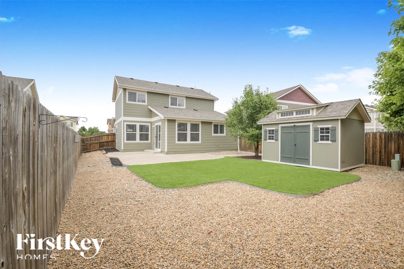 A house with a gravel driveway and a small garden.