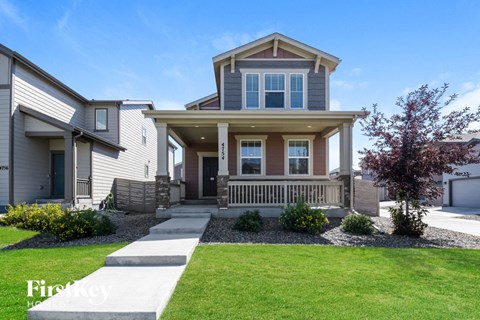 a home with a front porch and a lawn