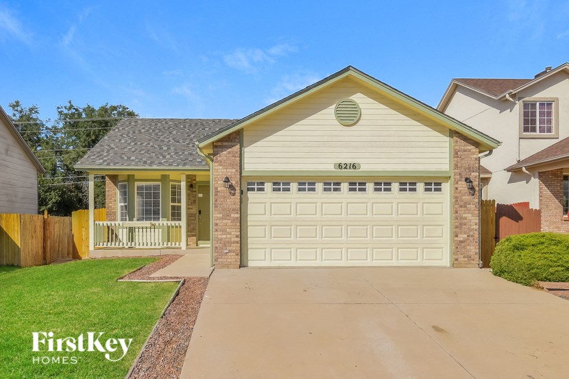 a white garage door in front of a house