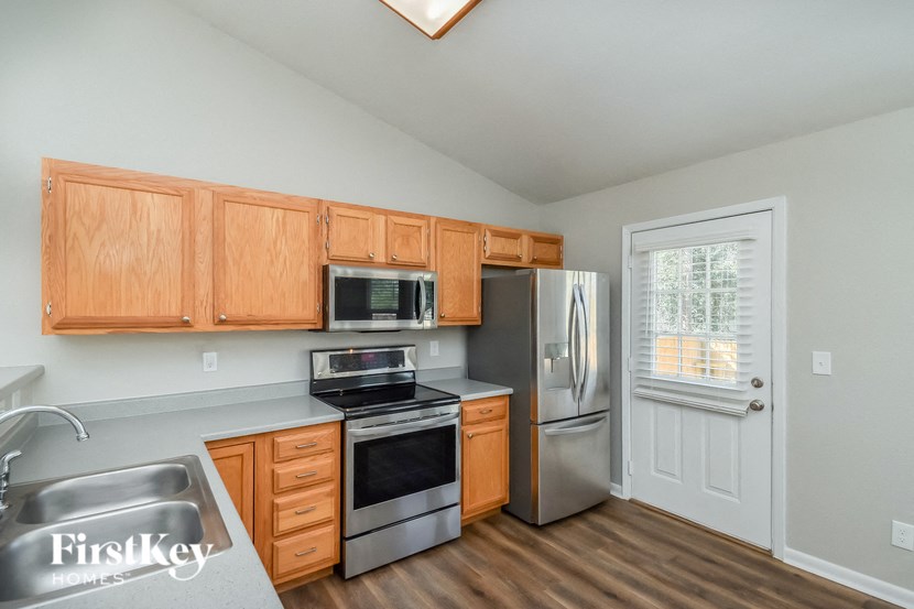 a kitchen with stainless steel appliances and wooden cabinets