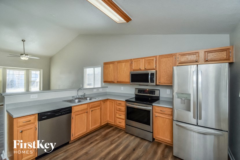 a kitchen with wooden cabinets and stainless steel appliances
