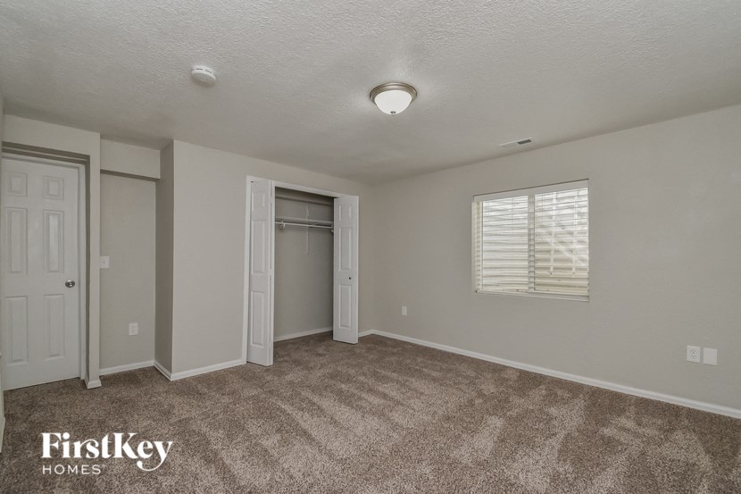 the upstairs bedroom has a closet and a door to the bathroom