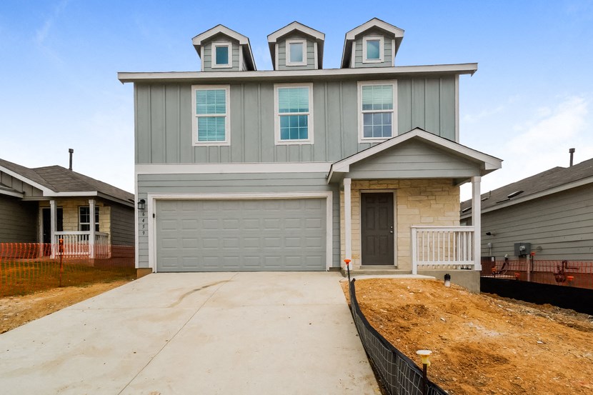 the front of a house with a driveway and a garage door