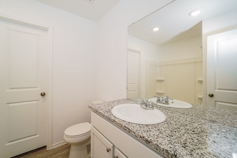 a bathroom with a sink and toilet and a mirror