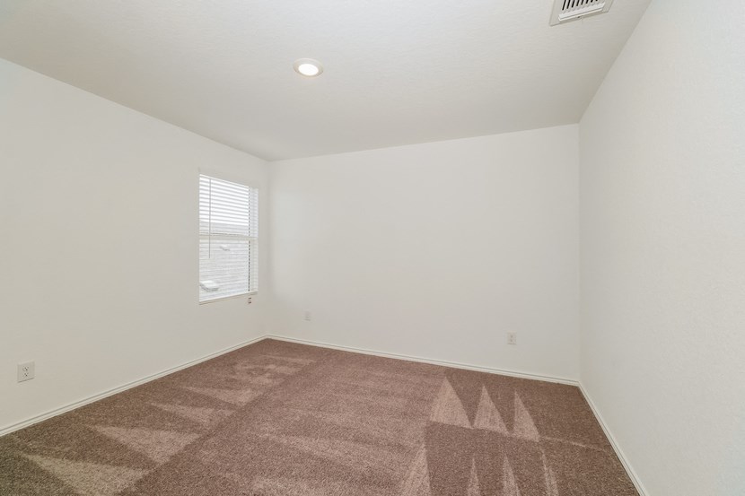 an empty room with carpet and a window