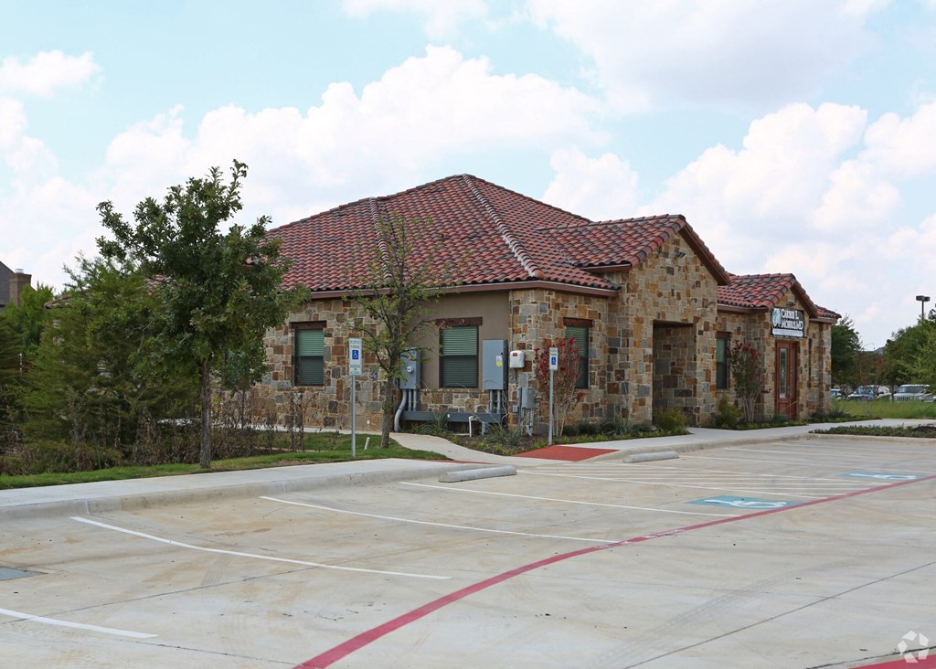 an empty parking lot in front of a building