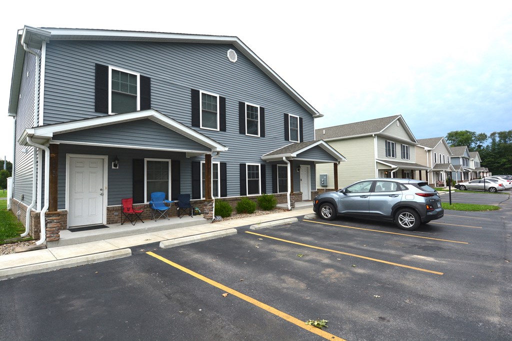 a car parked in a parking lot in front of a house