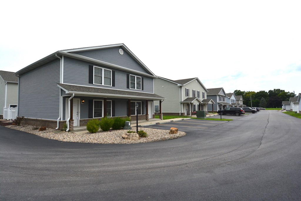 a row of houses with a street in front of them
