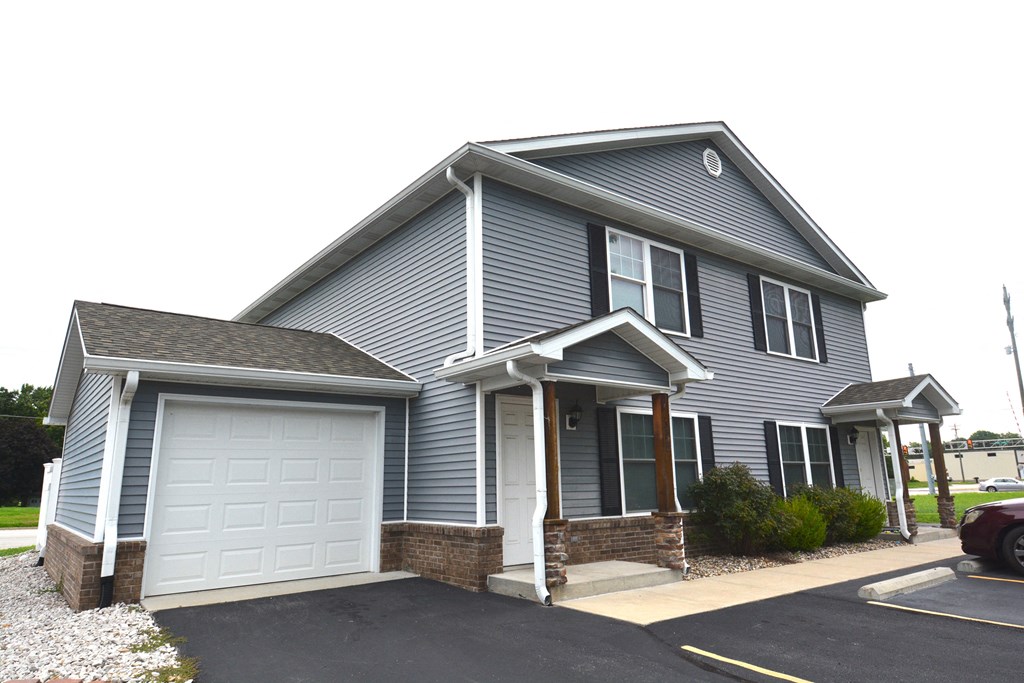 a blue house with a white garage door