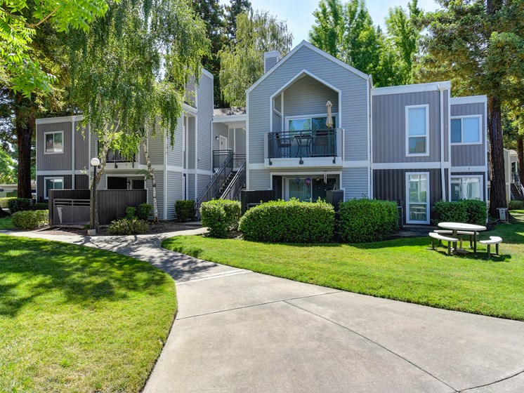 Apartment Exterior with Walkway, Grass and Trees