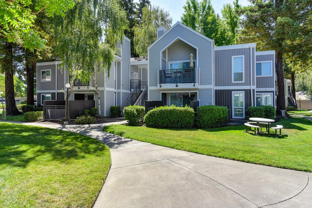 Apartment Exterior with Walkway, Grass and Trees at Rush River Apartments, Sacramento, CA