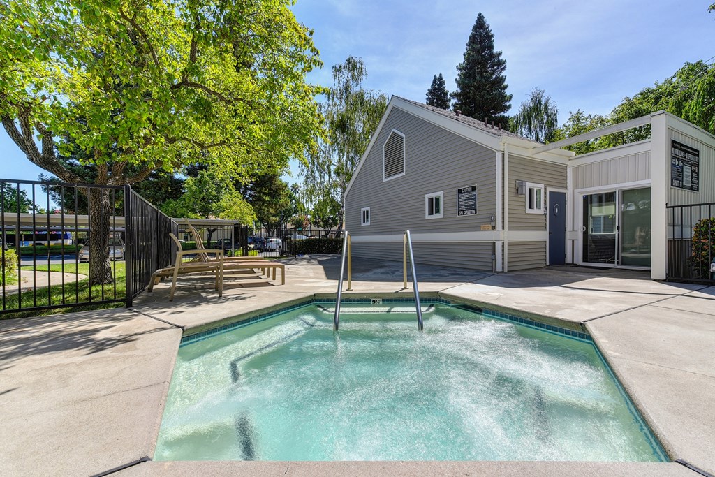 Spa with Apartment Exteriors and Gate at Rush River Apartments, California