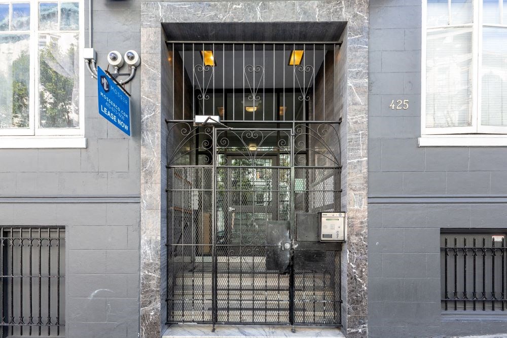 a door to a building with a wrought iron gate