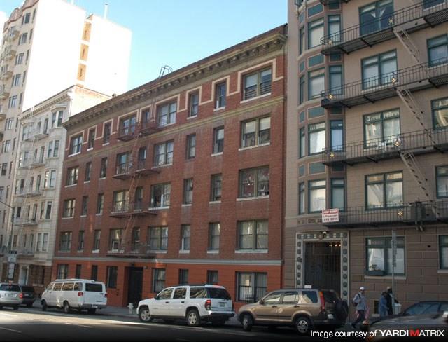 a brick building on a city street with cars