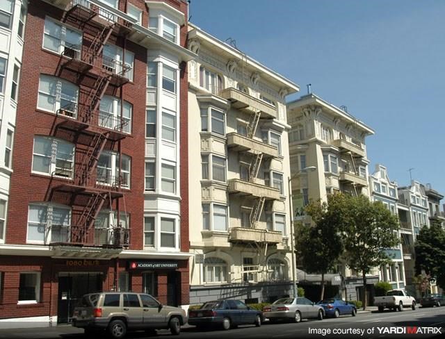 a city street with cars parked in front of a building