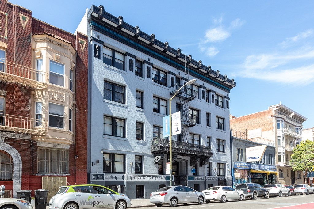 a three story apartment building on a city street