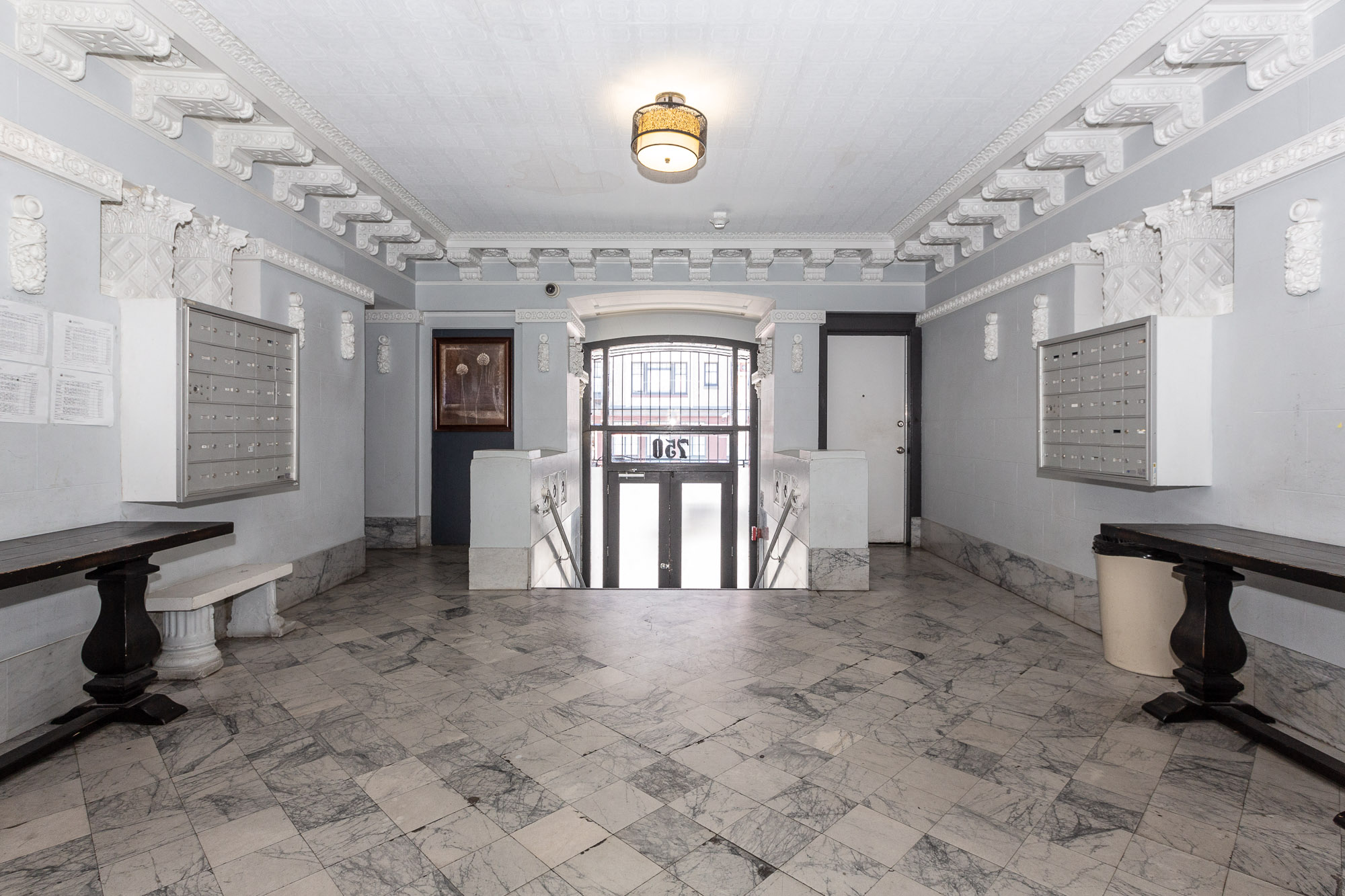 the lobby of a building with white walls and a glass door