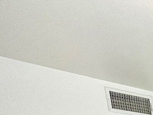 A spacious room with a tiled floor and a window on the wall.