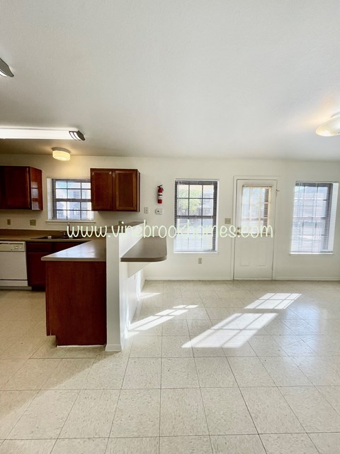 a kitchen with an island and a white counter top