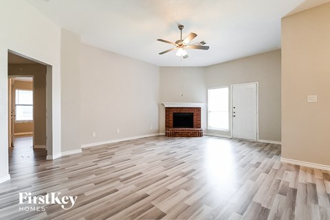 a living room with hardwood flooring and a fireplace