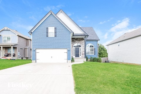 a blue house with a white garage door