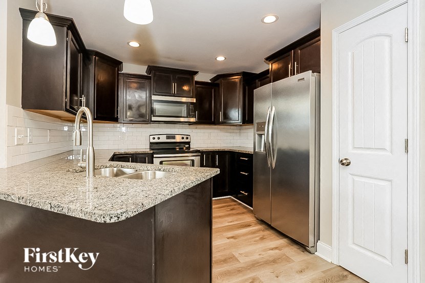 a kitchen with stainless steel appliances and granite counter tops