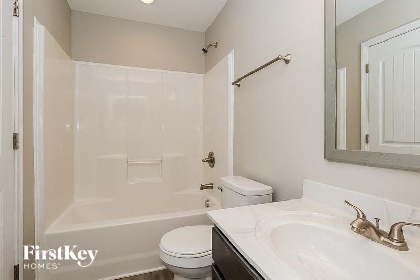a bathroom with a sink and a toilet and a shower