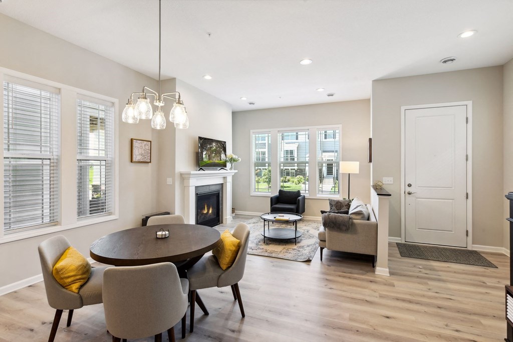 a living room with a table and chairs and a fireplace