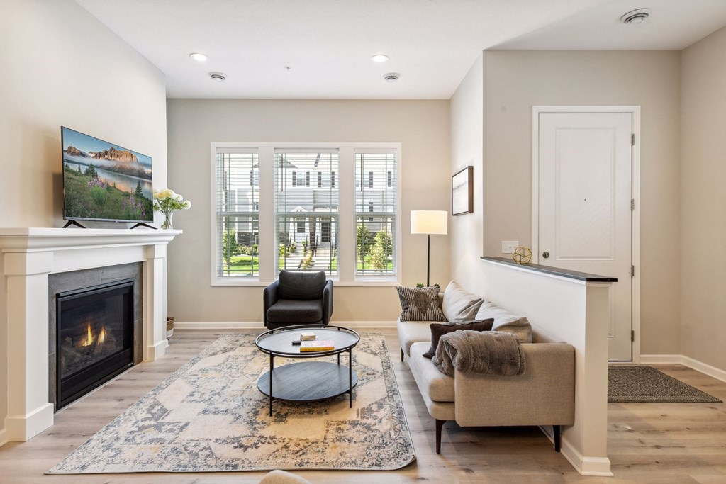 a living room with a couch and a chair and a fireplace