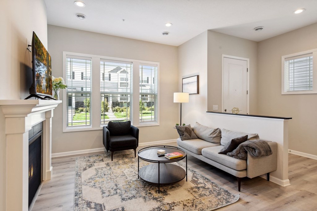 a living room with a couch and a chair and a fireplace