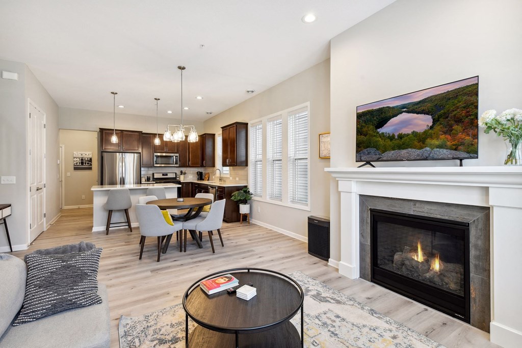 a living room with a fireplace and a table with chairs