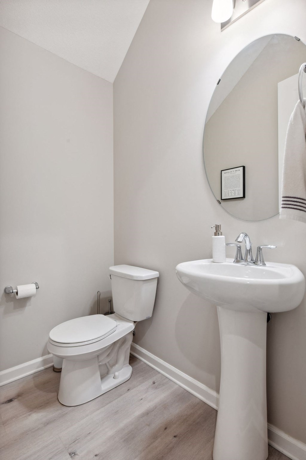 a white bathroom with a sink toilet and a mirror