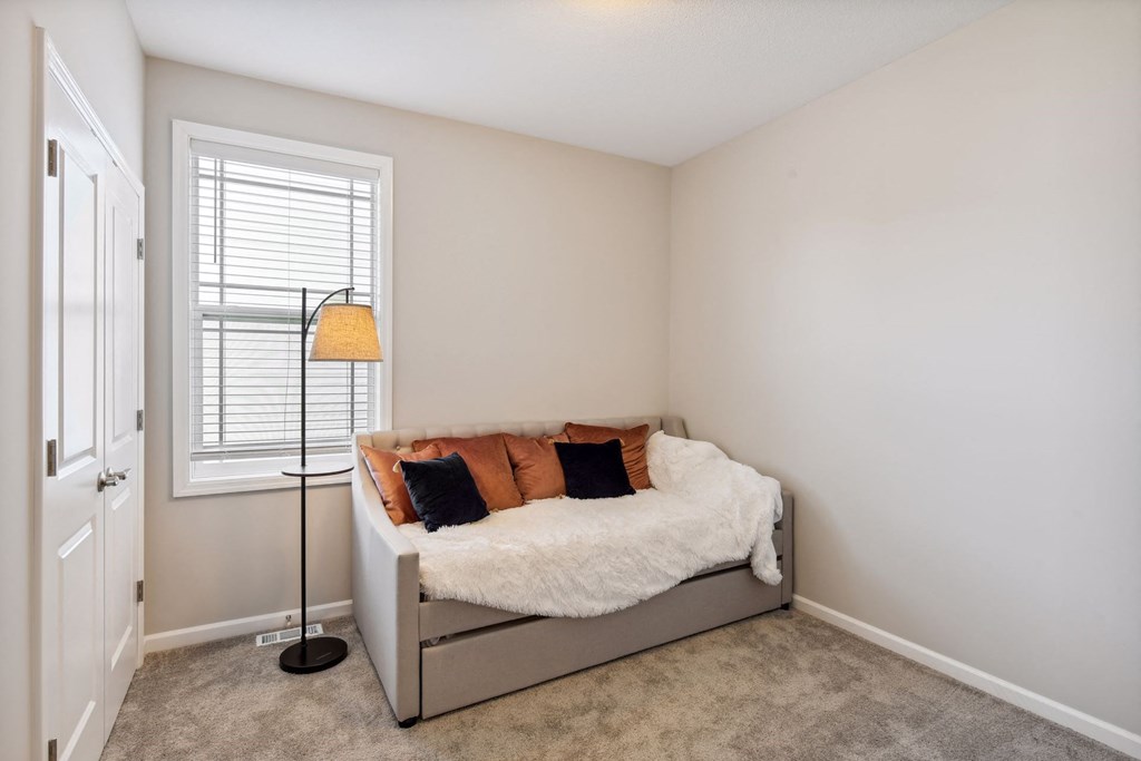 a bedroom with a bed and a window