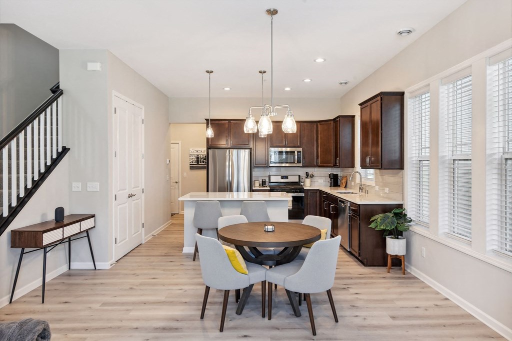 a kitchen and dining room with a table and chairs