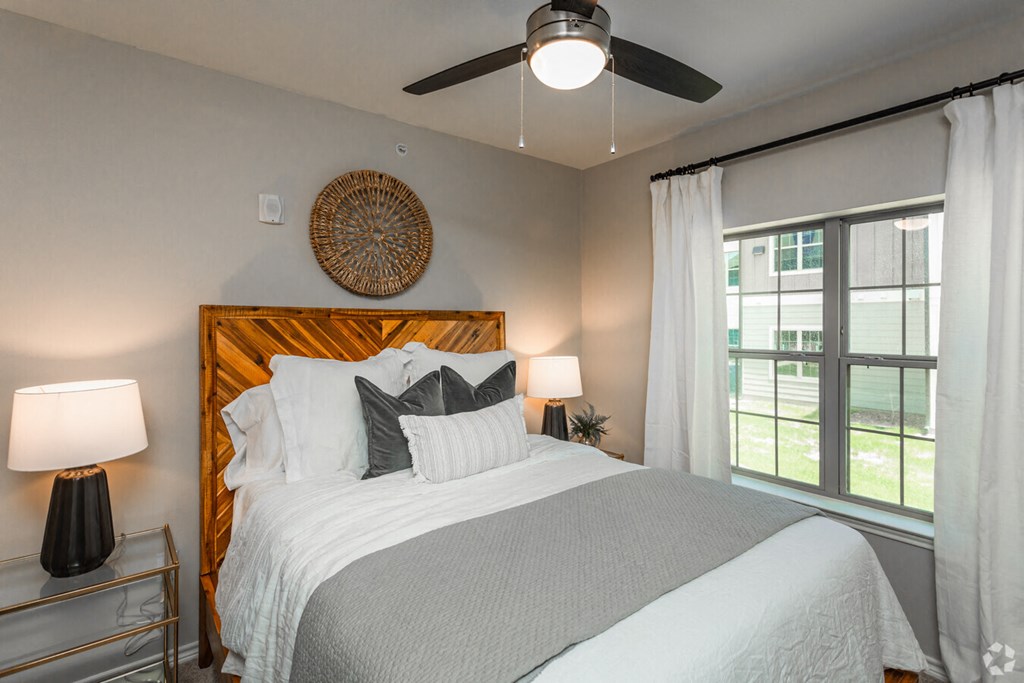 a bedroom with a bed and a ceiling fan