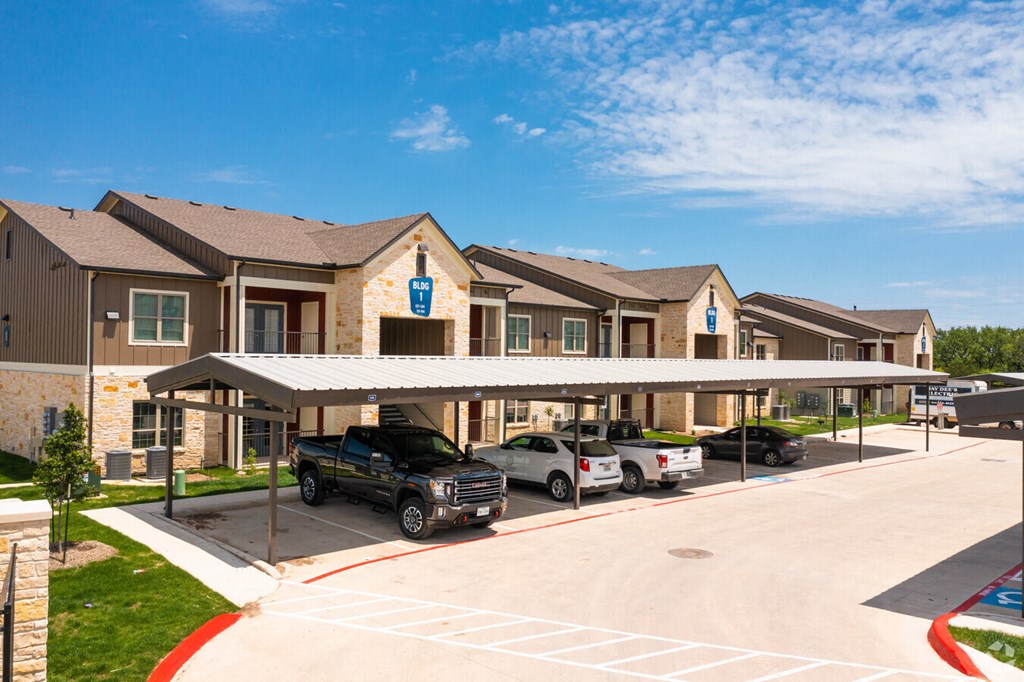 a parking lot with cars in front of a building