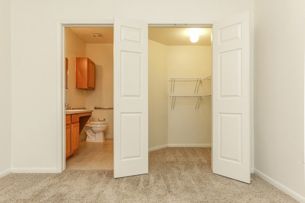 a room with a door open to a bathroom and a toilet
