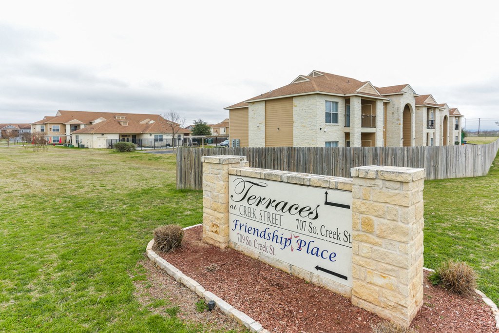 a group of houses in front of a sign