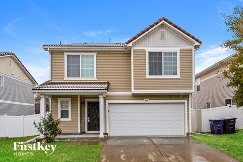 a yellow house with a white garage door