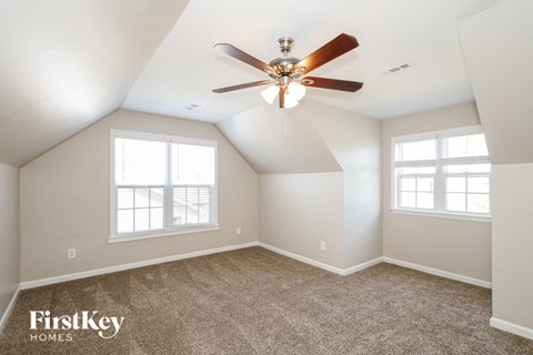 the master bedroom is spacious and has a ceiling fan
