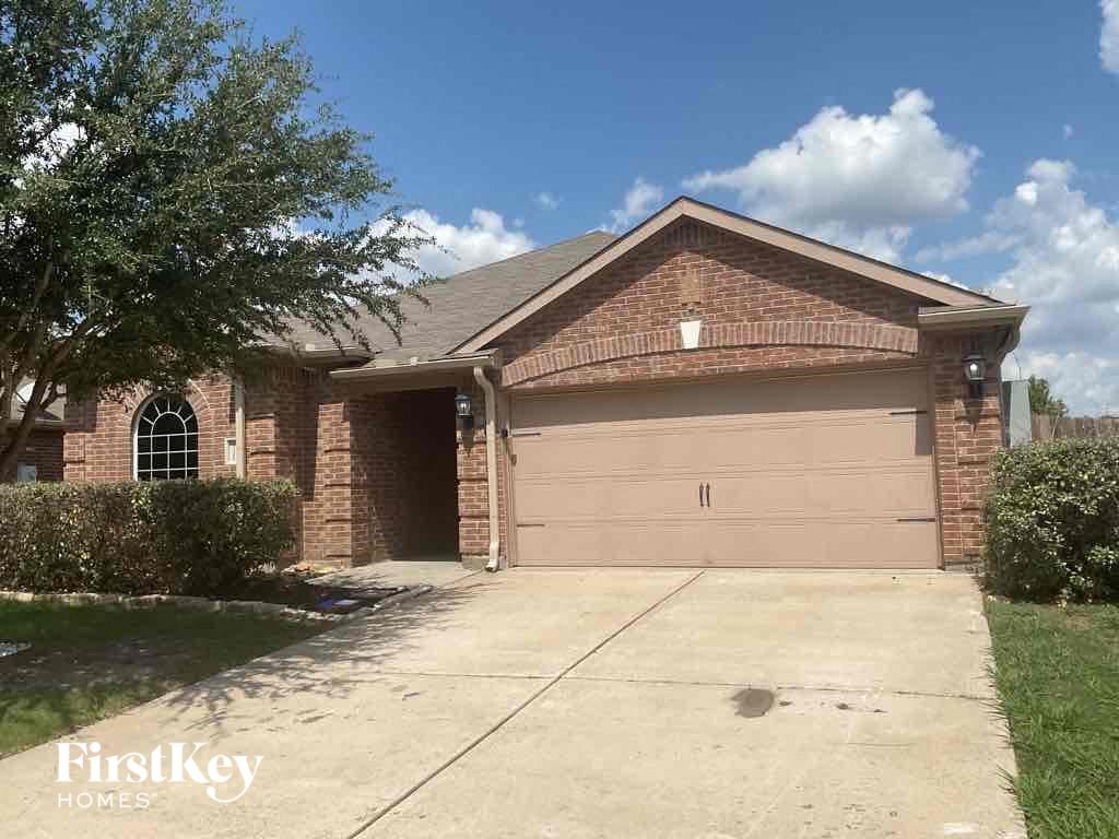 A house with a brown garage door is for sale.