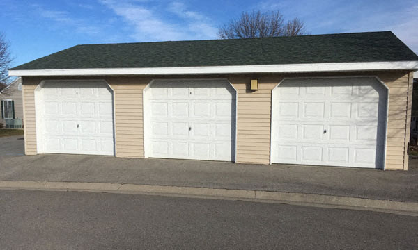 a three car garage with white garage doors
