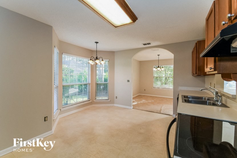an empty kitchen and living room with a large window