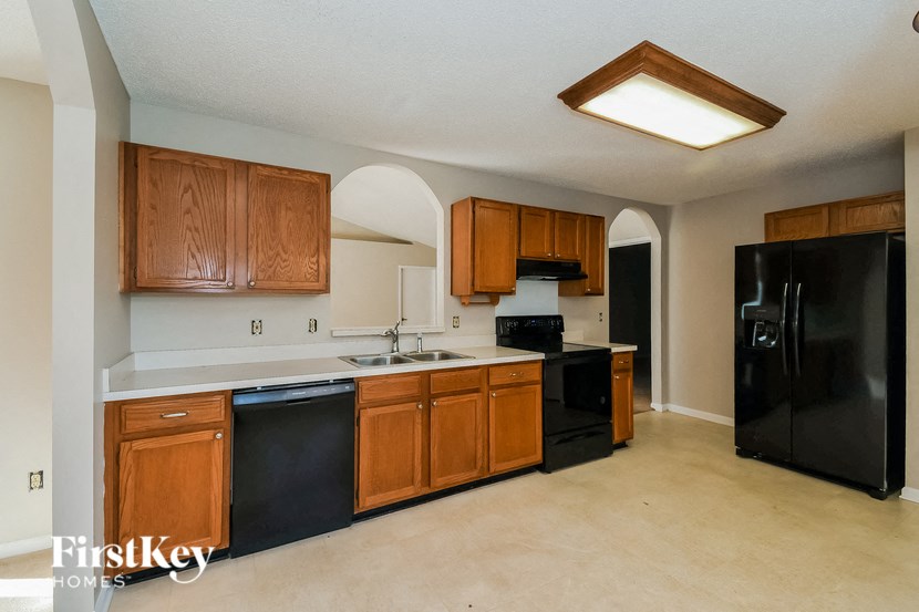 a kitchen with black appliances and wooden cabinets