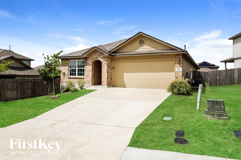 a house with a driveway and a garage door