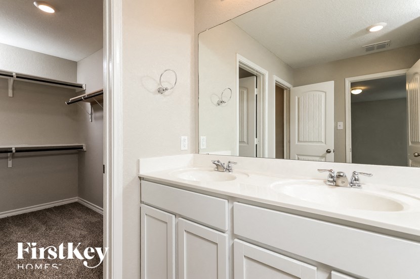 a bathroom with two sinks and a large mirror