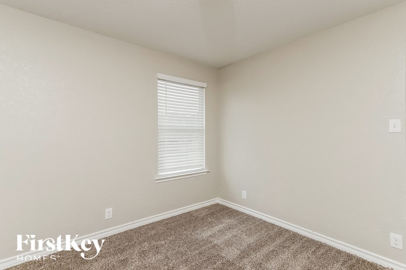 the upstairs bedroom has carpeting and a window