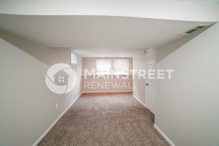 a bedroom with a carpeted floor and a door to a closet