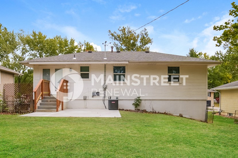 a small house with a lawn in front of it