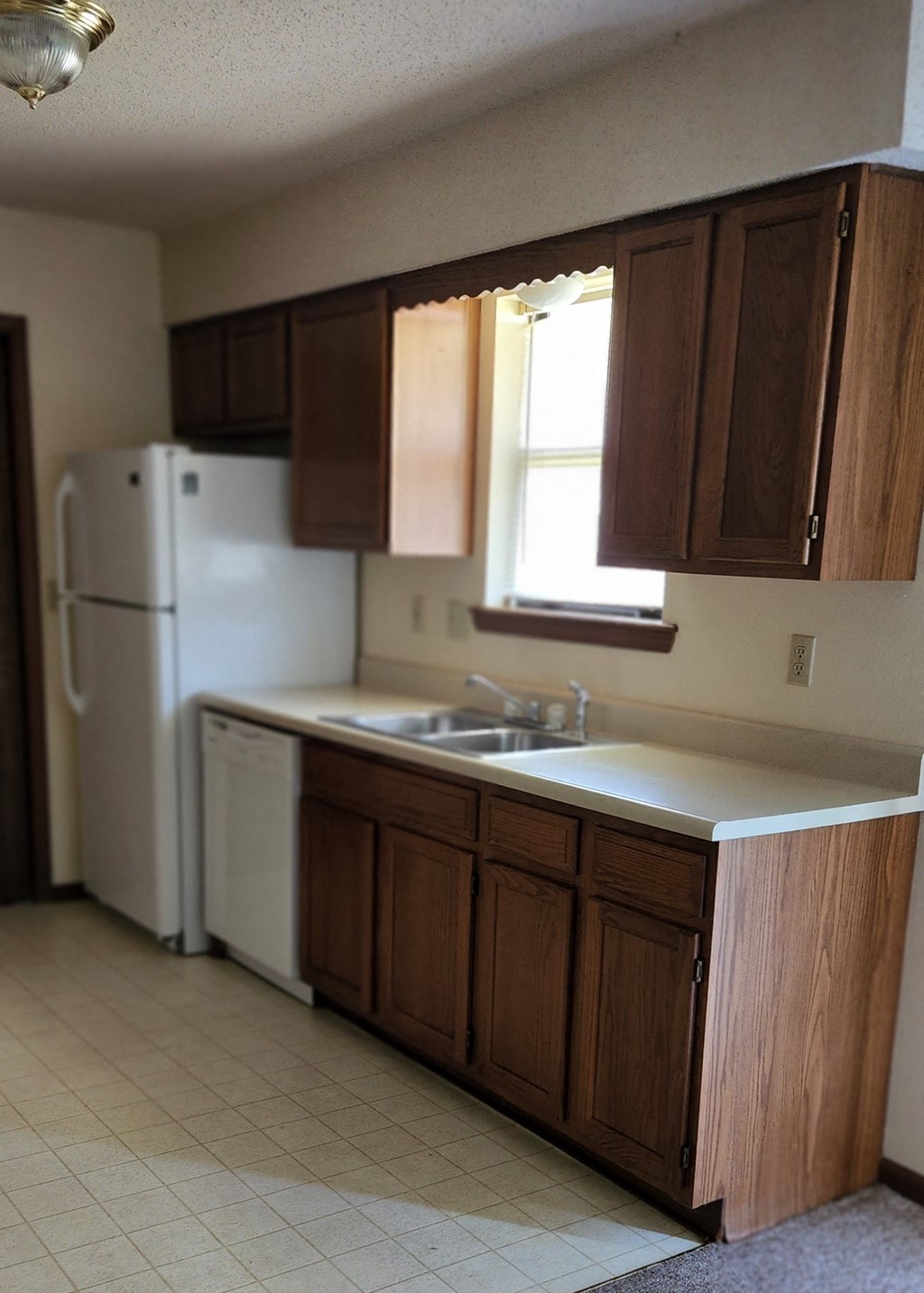 a kitchen with a sink and a refrigerator